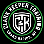 Circular black and green logo reading'GARY KEEPER TRAINING' with 'GRAND RAPIDS, MI' at the bottom and a white shield emblem in the center.